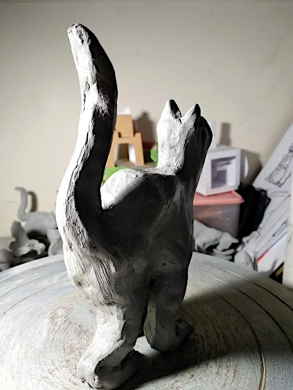 Small hand-modelled clay cat sculpture